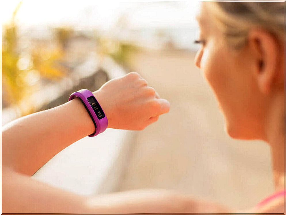 Woman wearing fitness bracelet to motivate herself to exercise again.