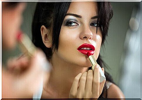 Woman painting her lips red