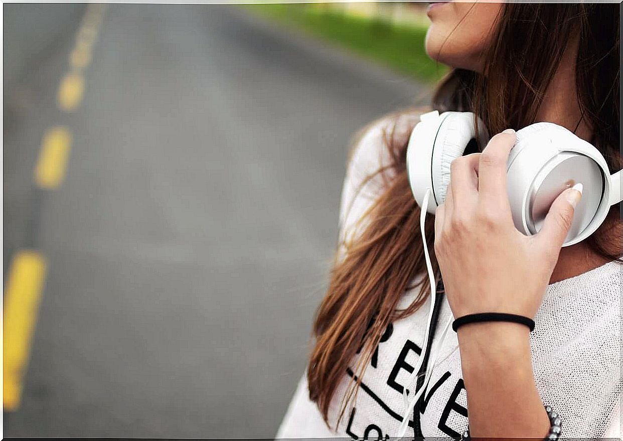 Girl with white headphones listening to music