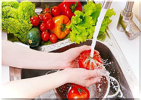 Woman washing tomatoes and vegetables