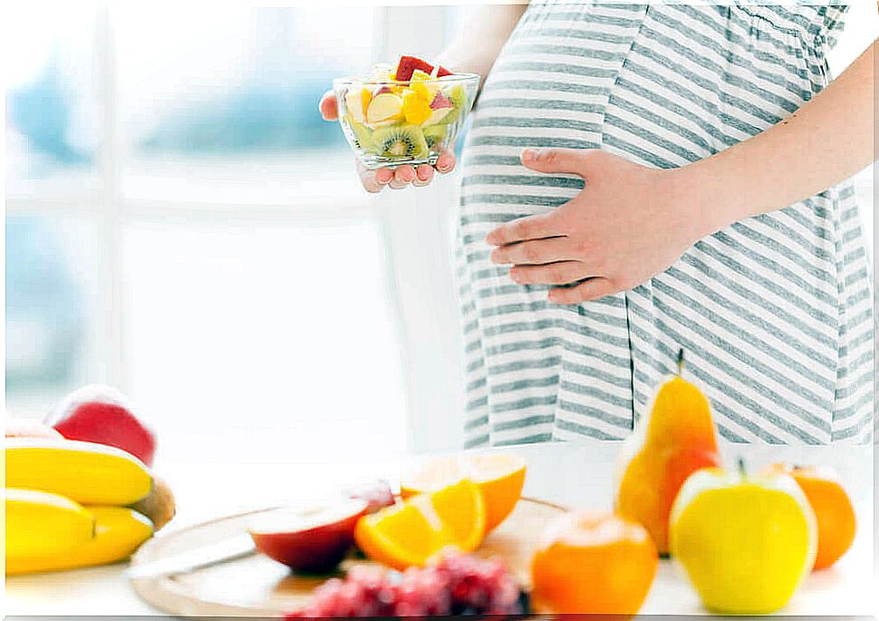 Pregnant woman with fruits