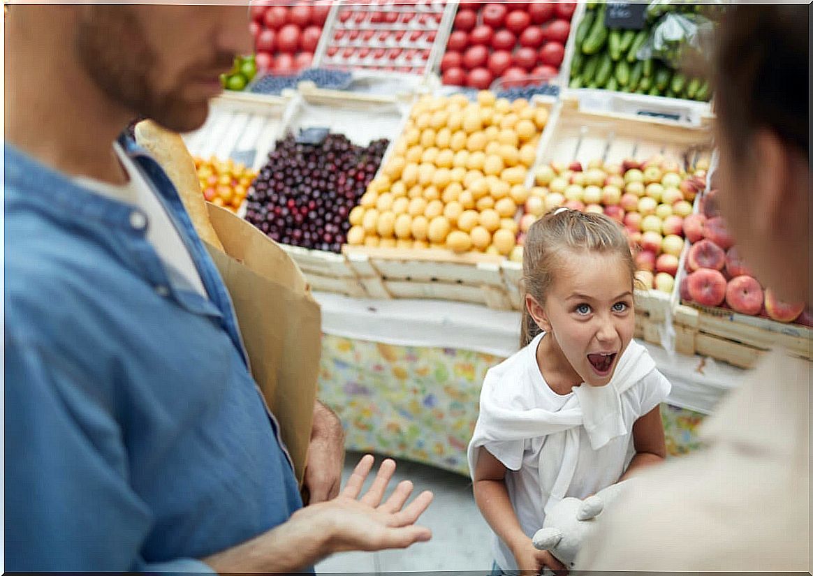 Spoiled daughter yells at parents in the market.